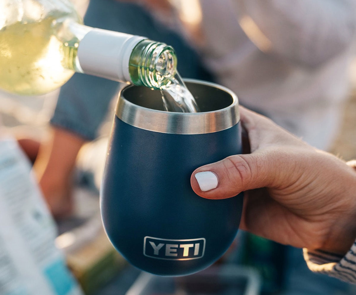 pouring drink into blue yeti rambler tumbler