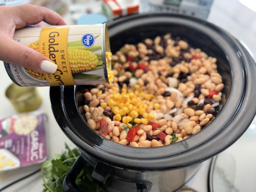 adding corn to tortilla soup