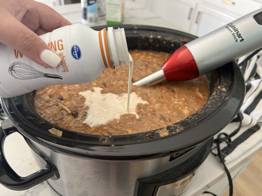 adding cream to tortilla soup