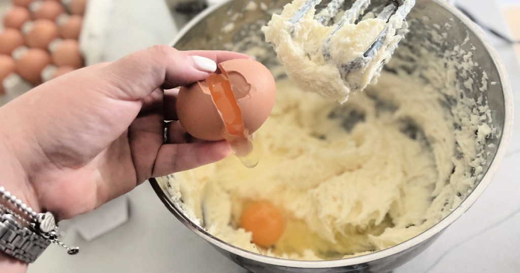 adding eggs to cake batter