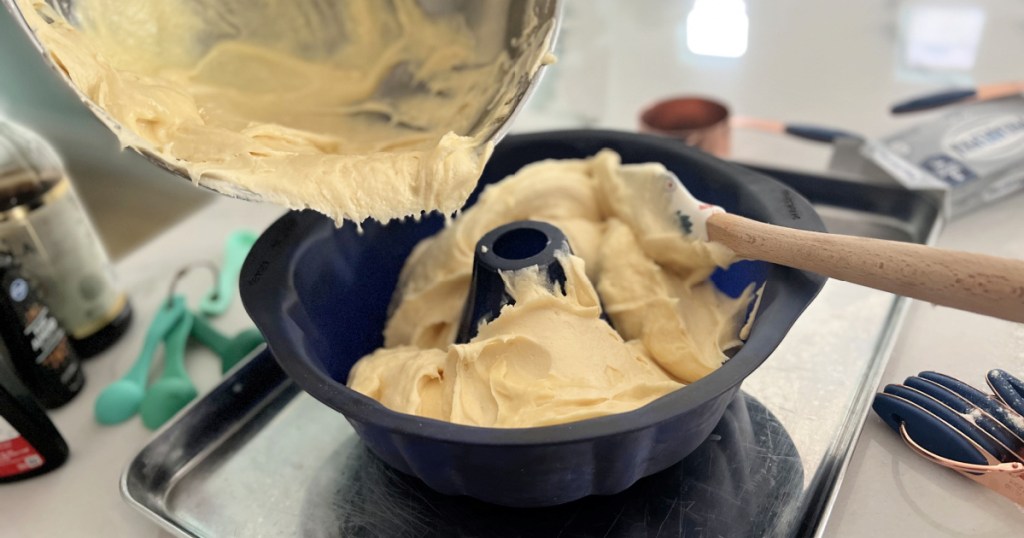 adding pound cake batter to bundt cake pan