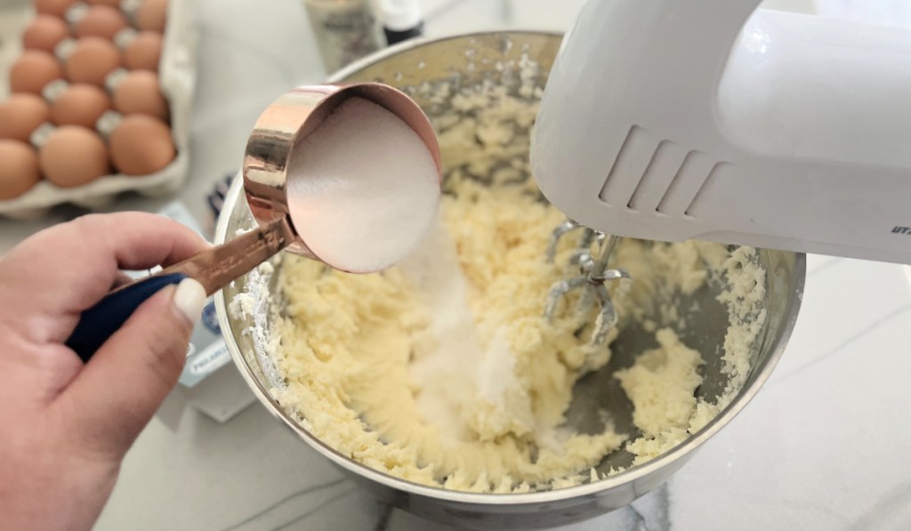 adding sugar to cake batter