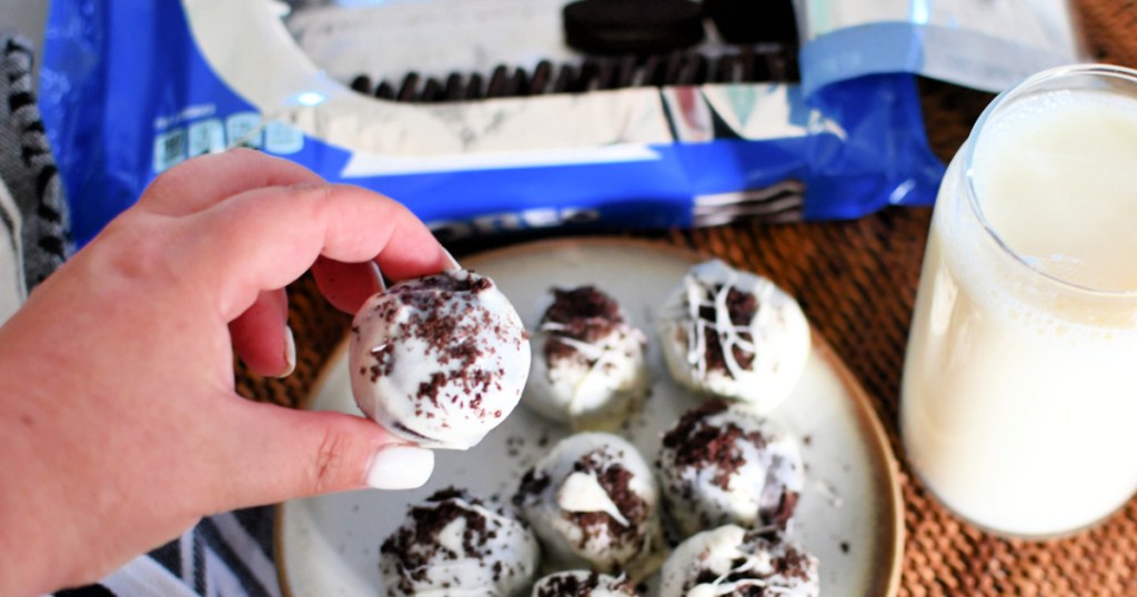 holding an Oreo cream cheese ball