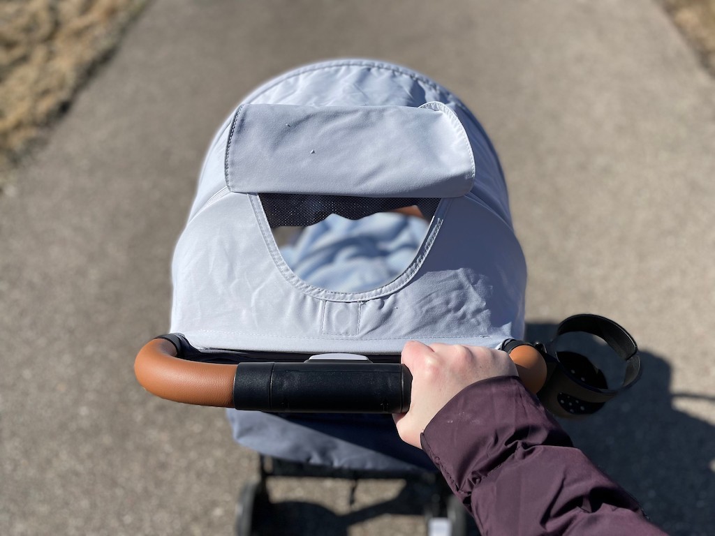 a person pushing a baby stroller they borrowed through a baby item rental business