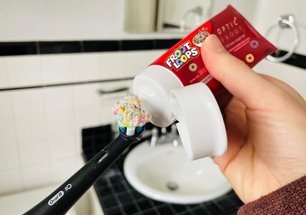 putting toothpaste on brush