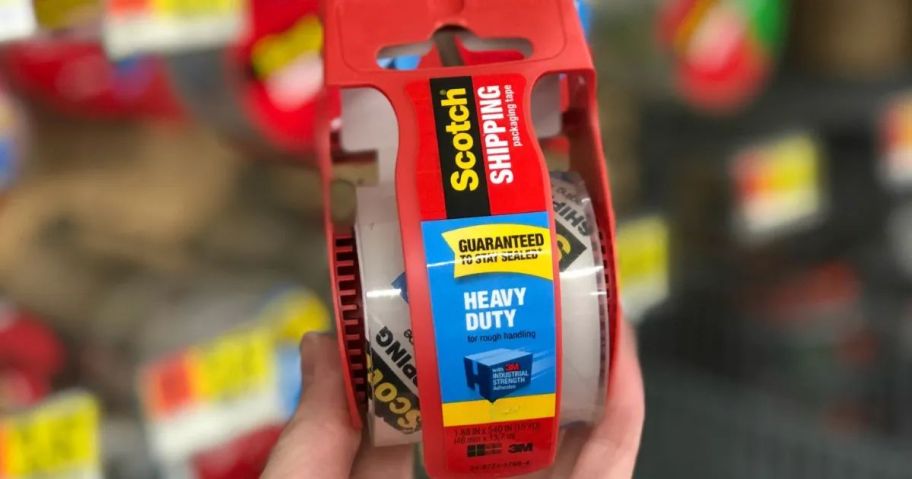 person holding scotch shipping tape