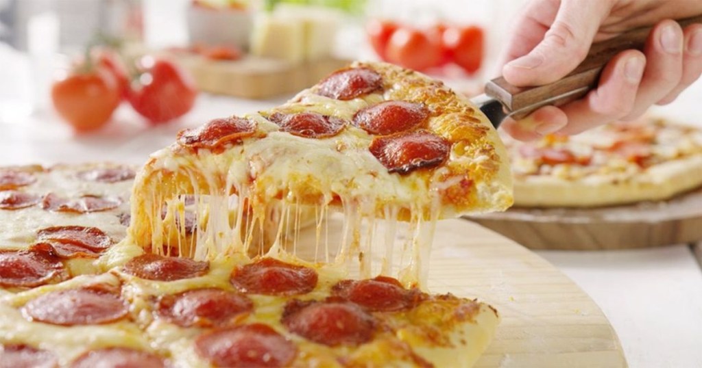 serving a slice of pizza from a whole pie