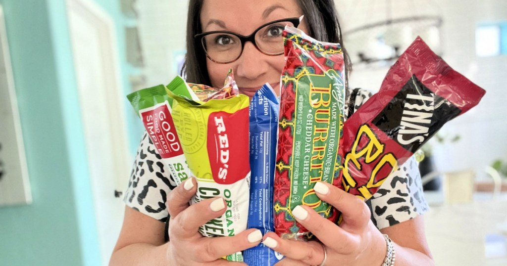 woman holding a bunch of frozen burritos