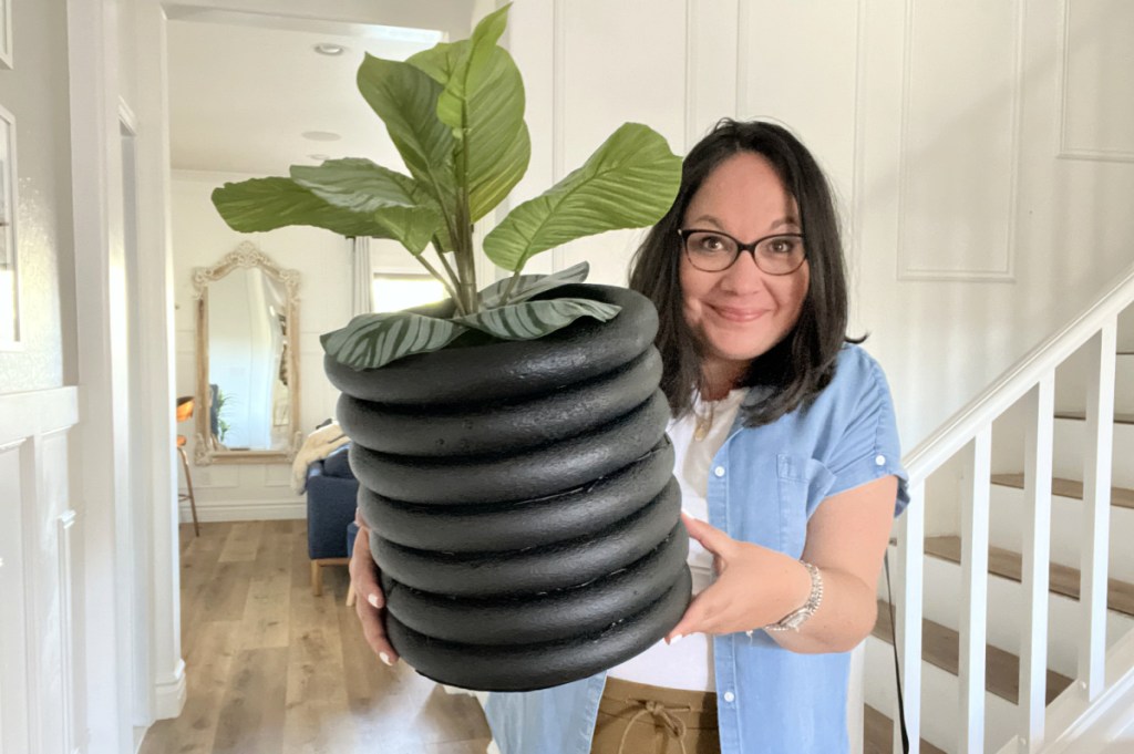 woman holding dollar tree diy planter