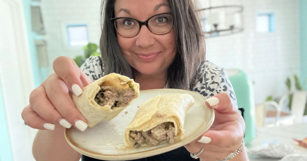 woman holding the trader joes burrito