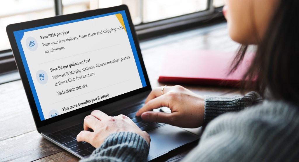 woman looking at Walmart Plus website on a macbook