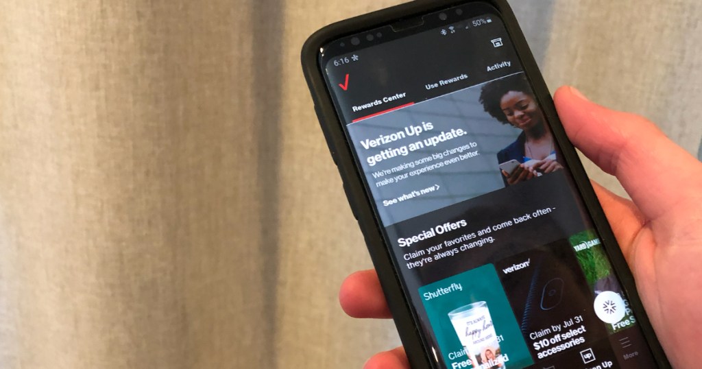 Hand holding phone with Verizon Up