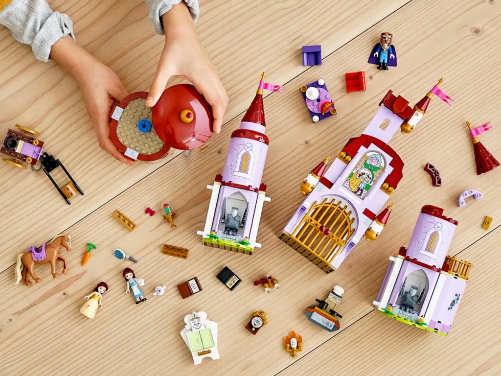 child playing with lego pieces on wood floor