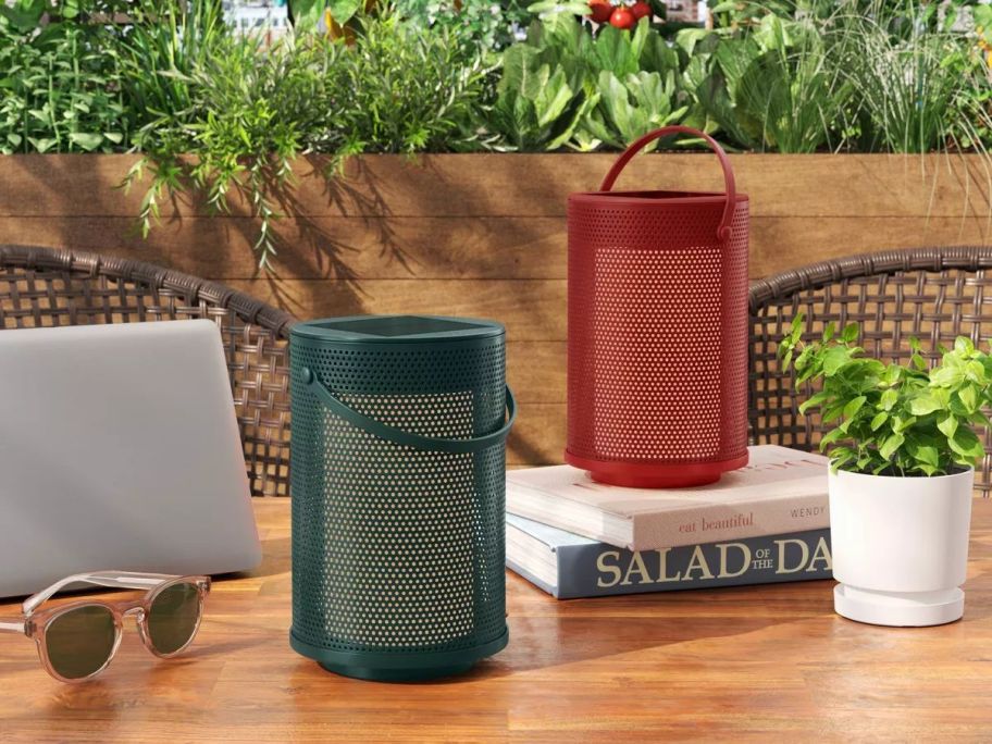 A table with two Room Essentials Mesh Solar & Rechargeable USB LED Lanterns