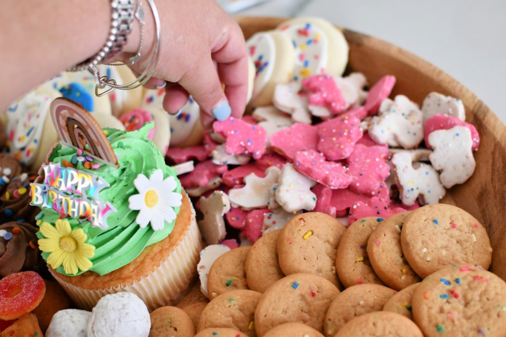 adding circus cookies to birthday charcuterie board