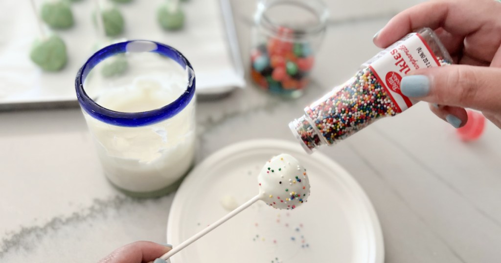 adding sprinkles to cake pops