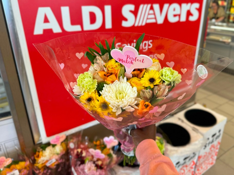 hand holding mutlifcolored flower bouquet