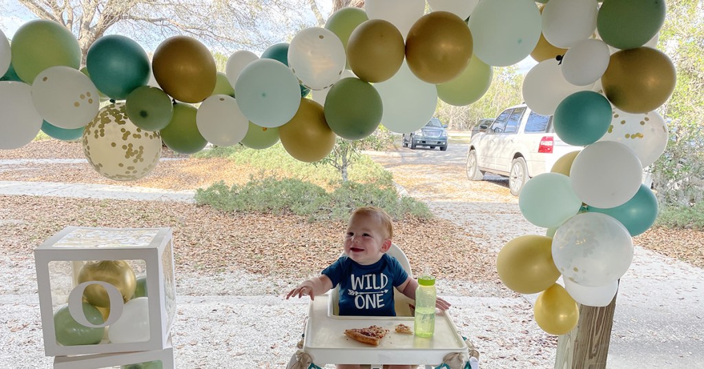 baby underneath diy balloon arch