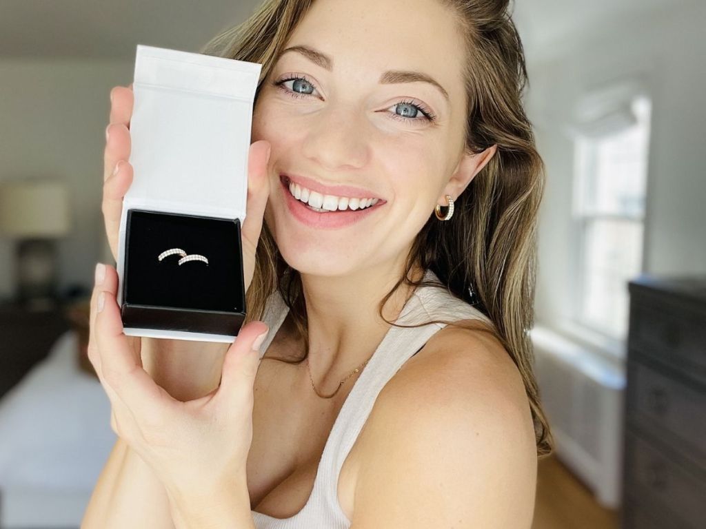 woman holding Cate & Chloe box with hoop earrings