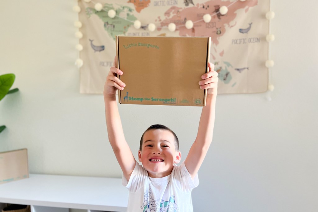 boy holding up subscription box