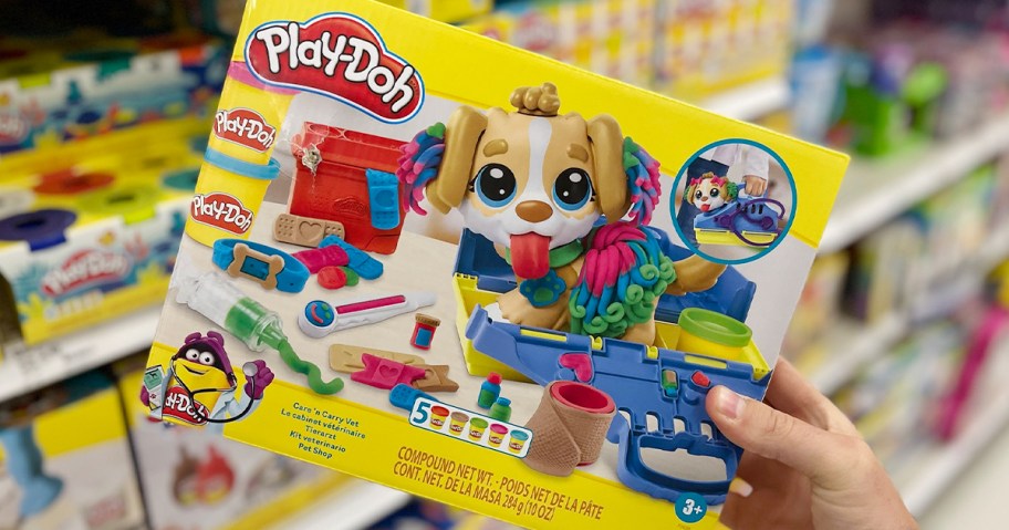 hand holding play doh care n carry vet set