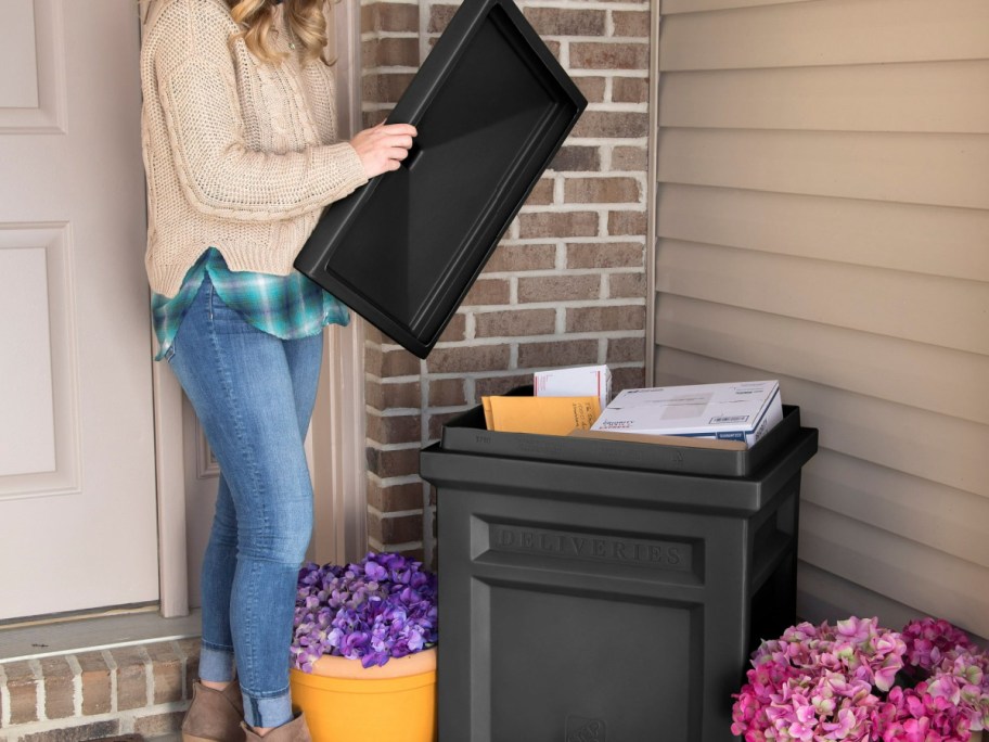 woman lifting the lid from a step2 package delivery box