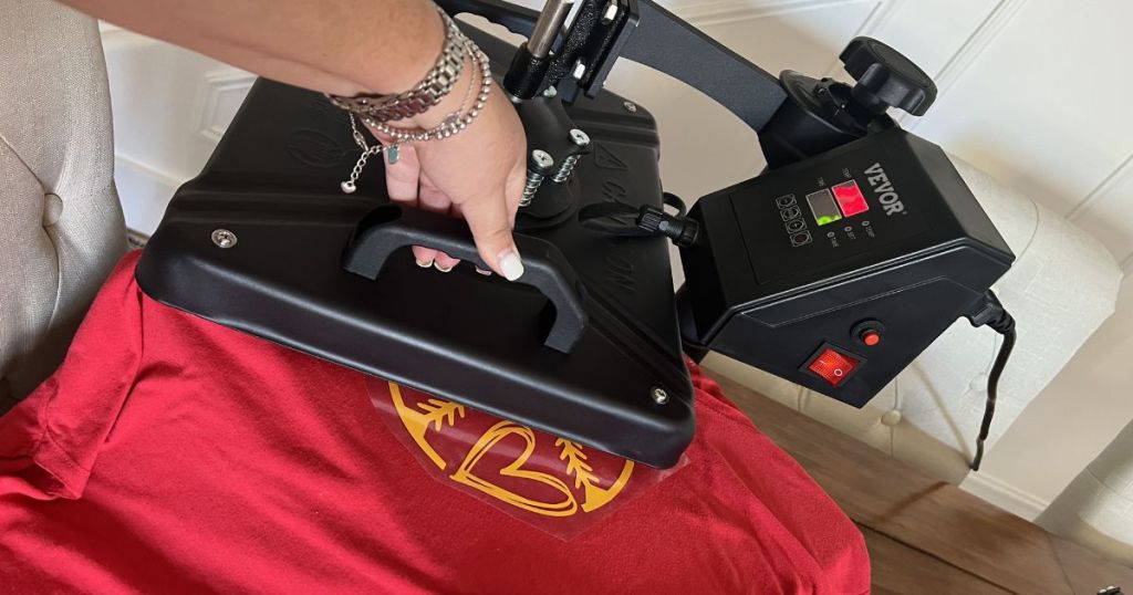 woman using heat press on tee