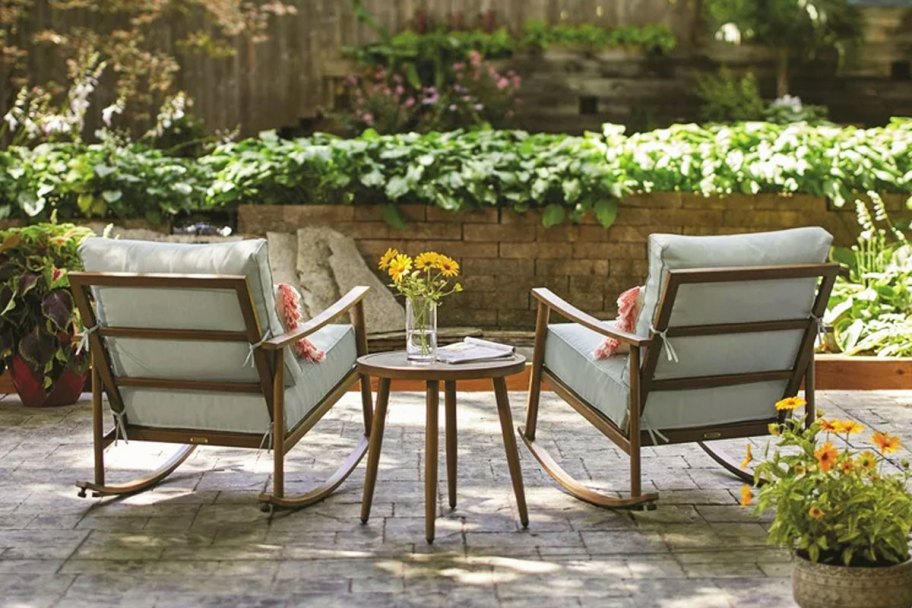 two patio rocking chairs and side table