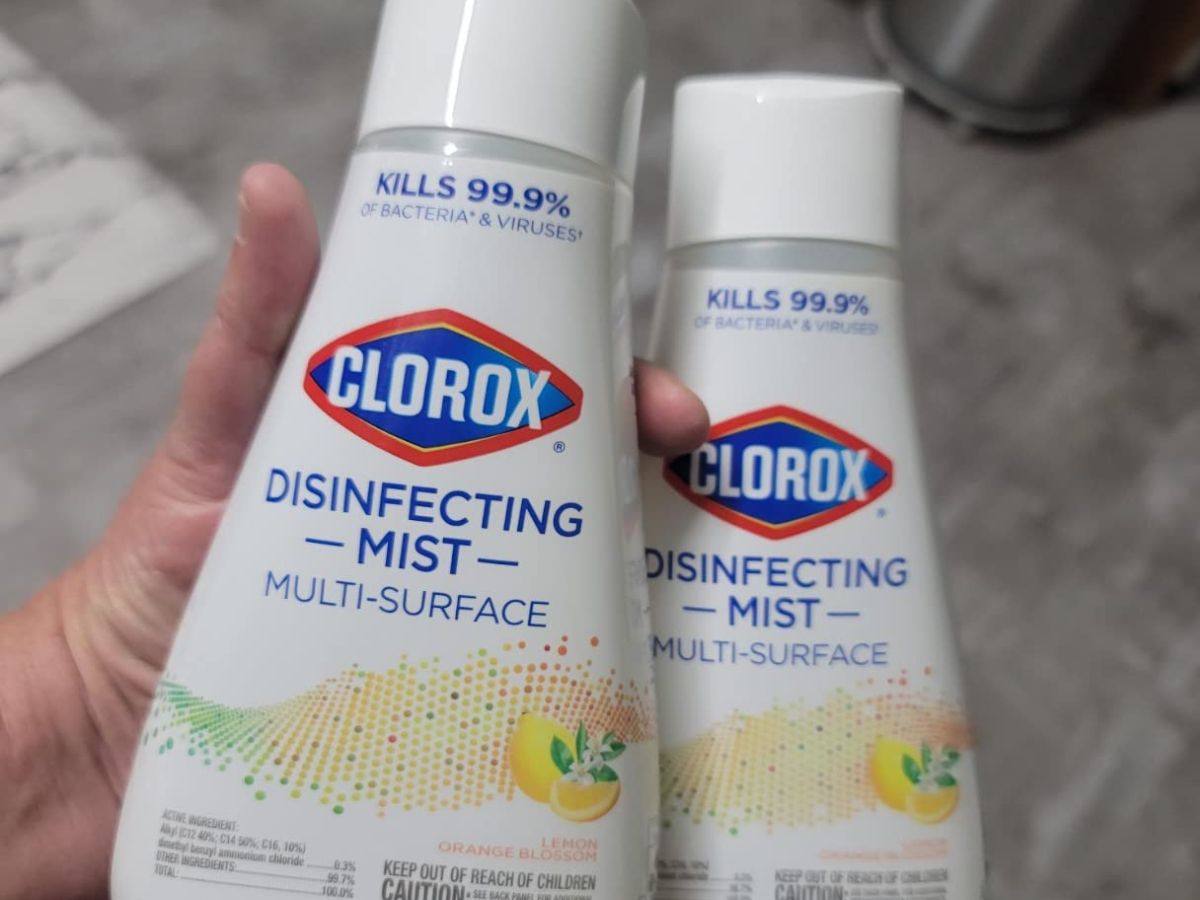 hand holding a Clorox Disinfecting Mist spray and refill bottle