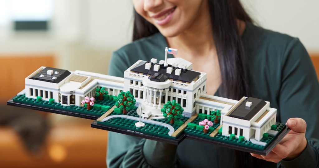 woman holding a onlinepleted LEGO The White House Building Set