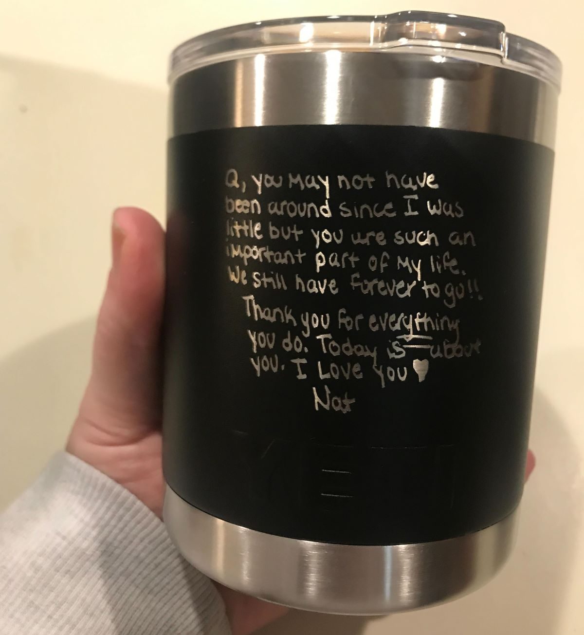 Hand holding a personalized YETI 