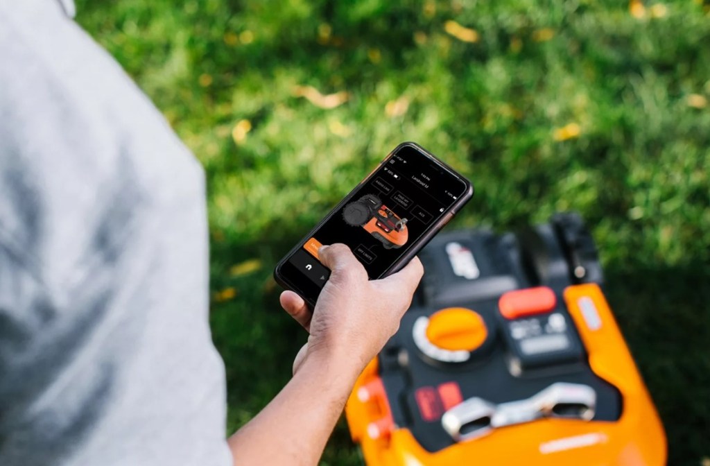 person using an app with a lawn mower