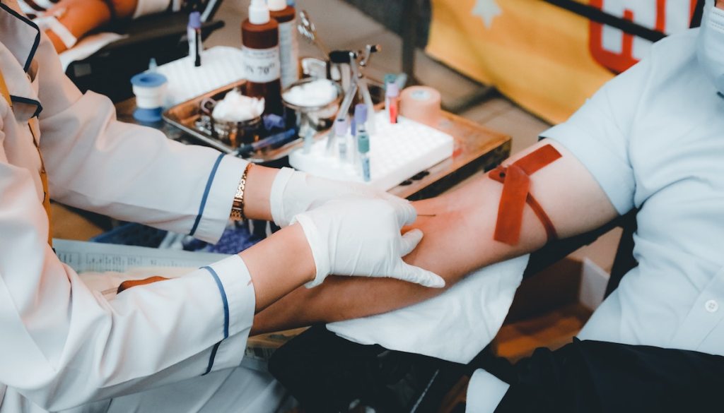 close up of person making blood donation