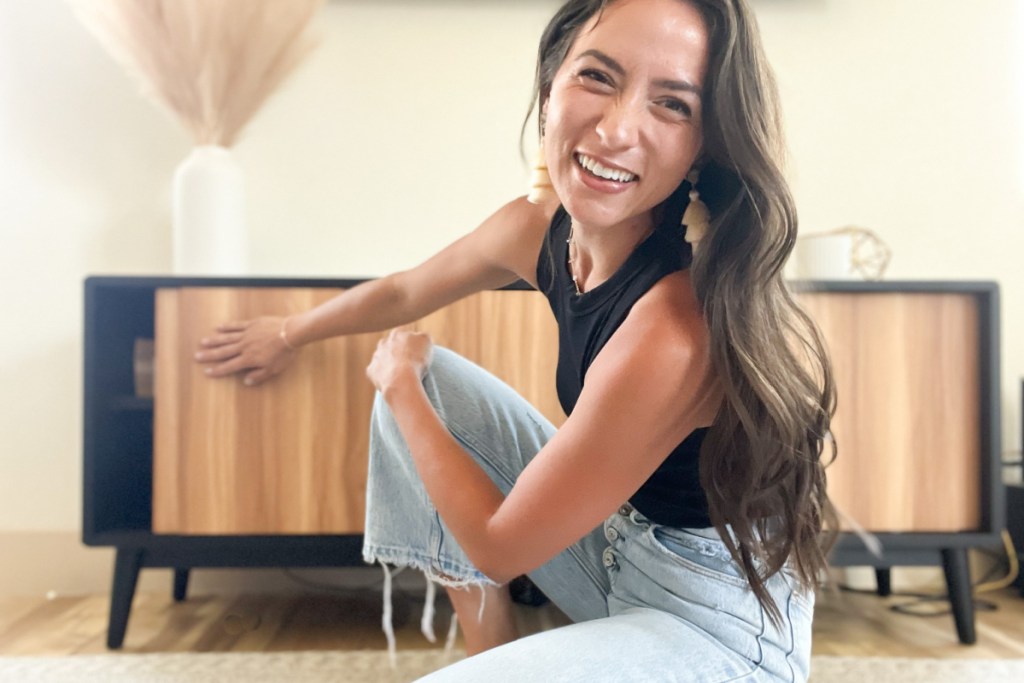 woman opening door of tv stand