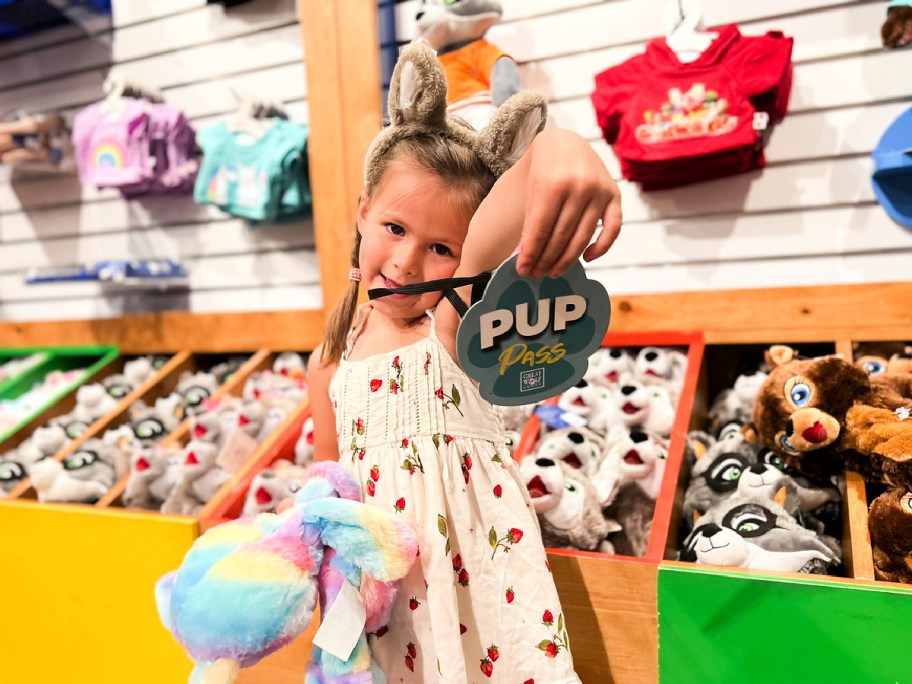 girl holding pup pass at great wolf lodge