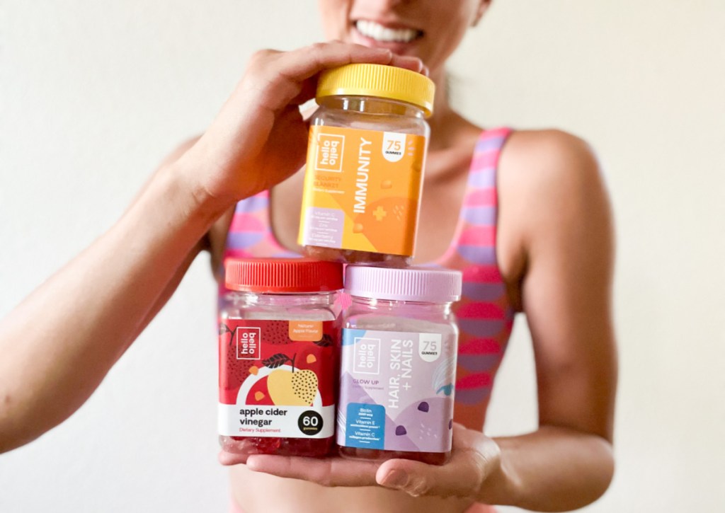 woman holding vitamin jars