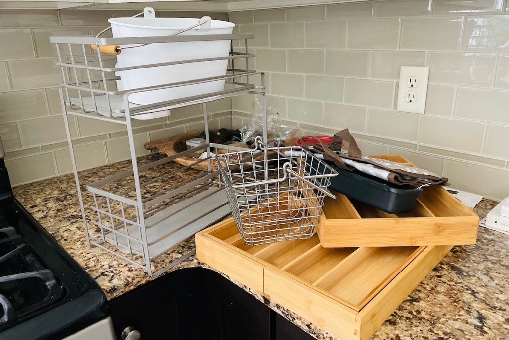 pile of random metal and wood organizers on granite countertop