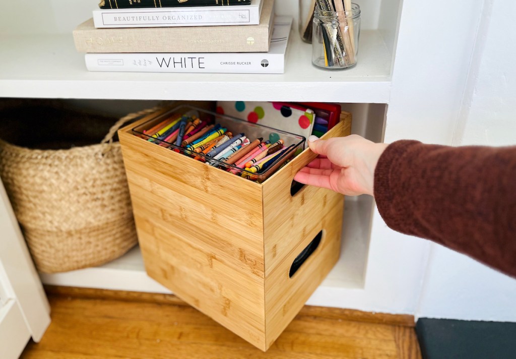 hand pulling out bamboo stacked organizers