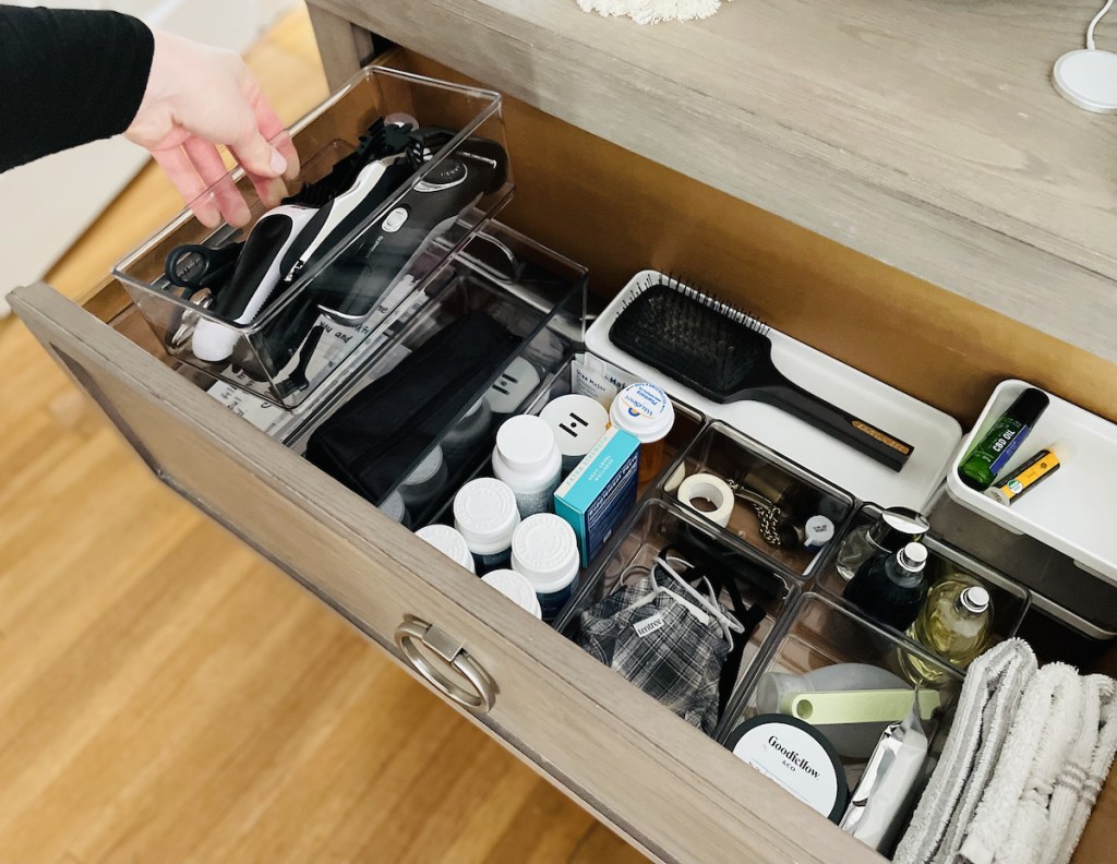 hand holding clear bin organizer with sharving tools inside