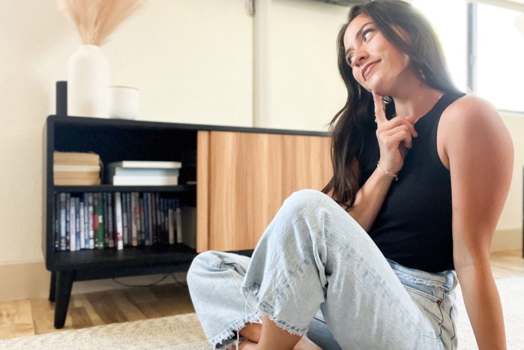 woman sitting in front of tv table