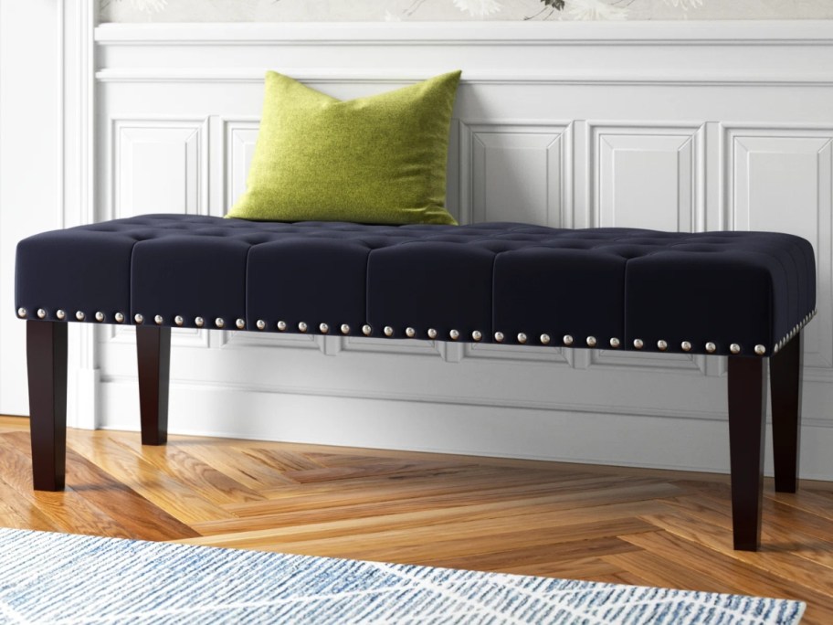 dark blue velvet upholstered bench in an entryway