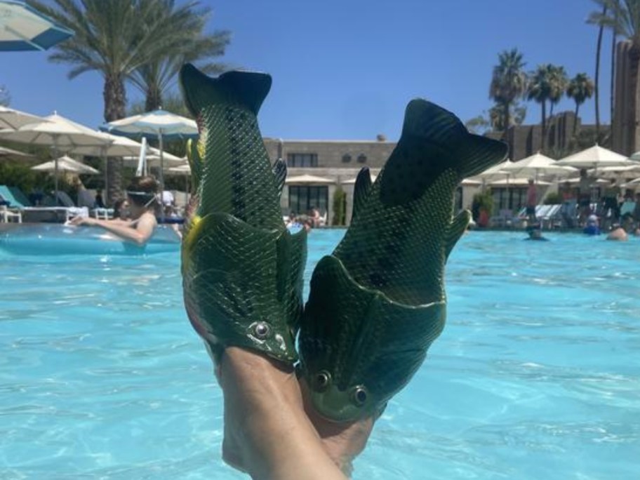 man wearing fish sandals in pool