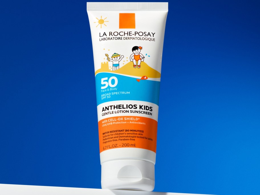 bottel of La Roche-Posay Anthelios Kids Gentle Lotion Sunscreen with blue background