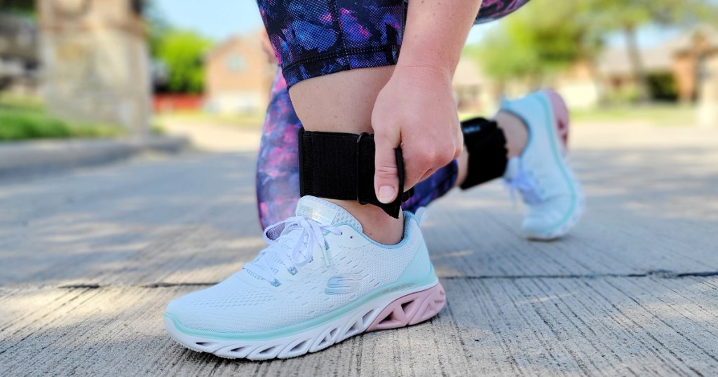 Lady strapping on Ankle Weights