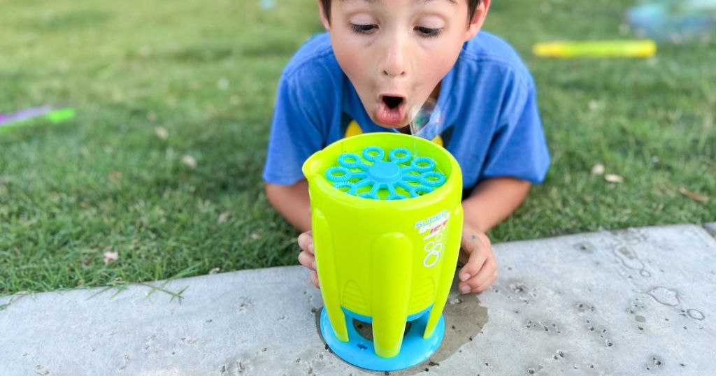 boy looking at a Maxx Bubbles bubble maker