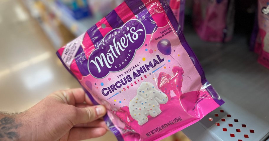 holding a bag of frosted animal crackers