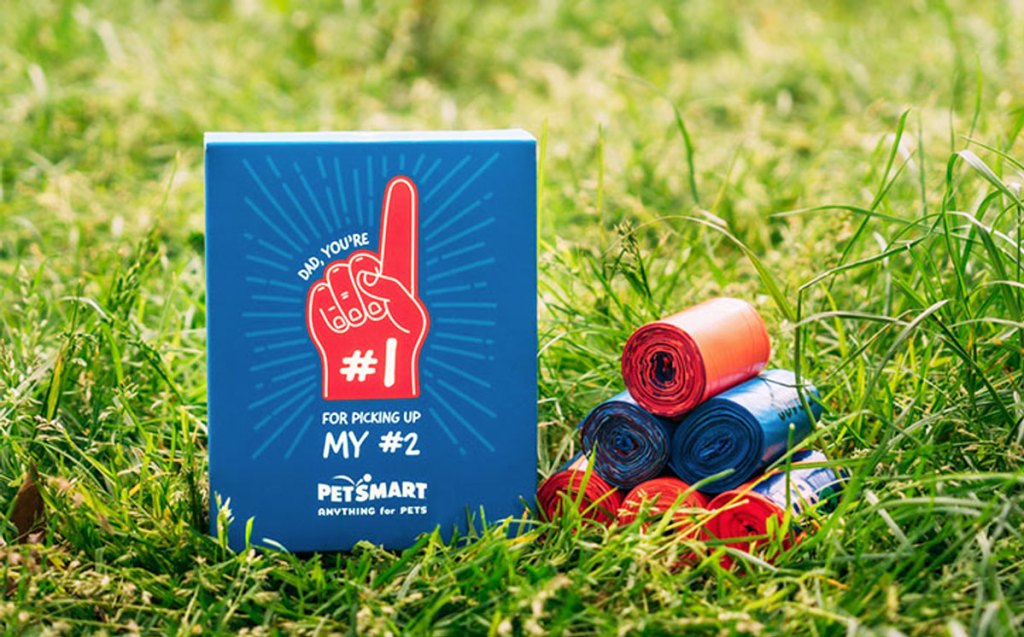 poop bags and father's day themed box in grass