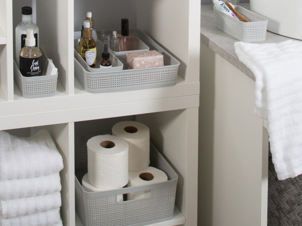 gray organizing baskets in bathroom shelves