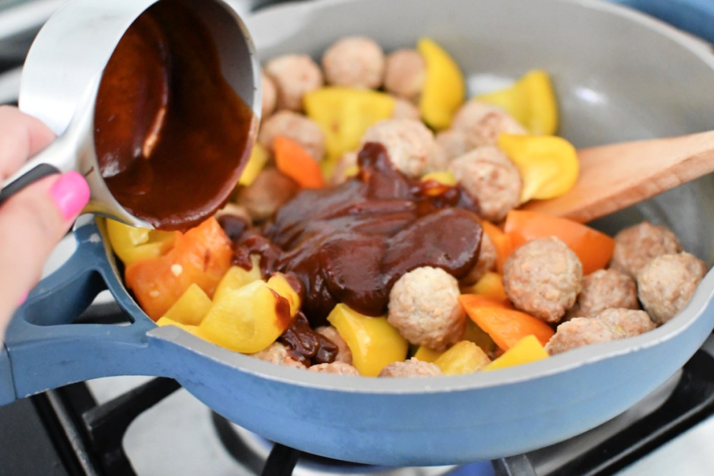 adding bbq sauce to skillet meal