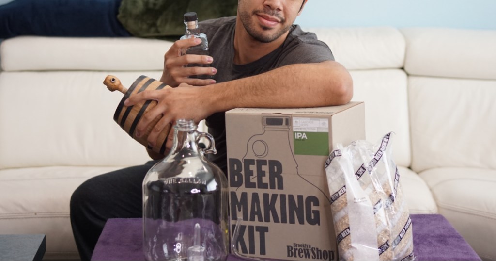 man holding beer making kit